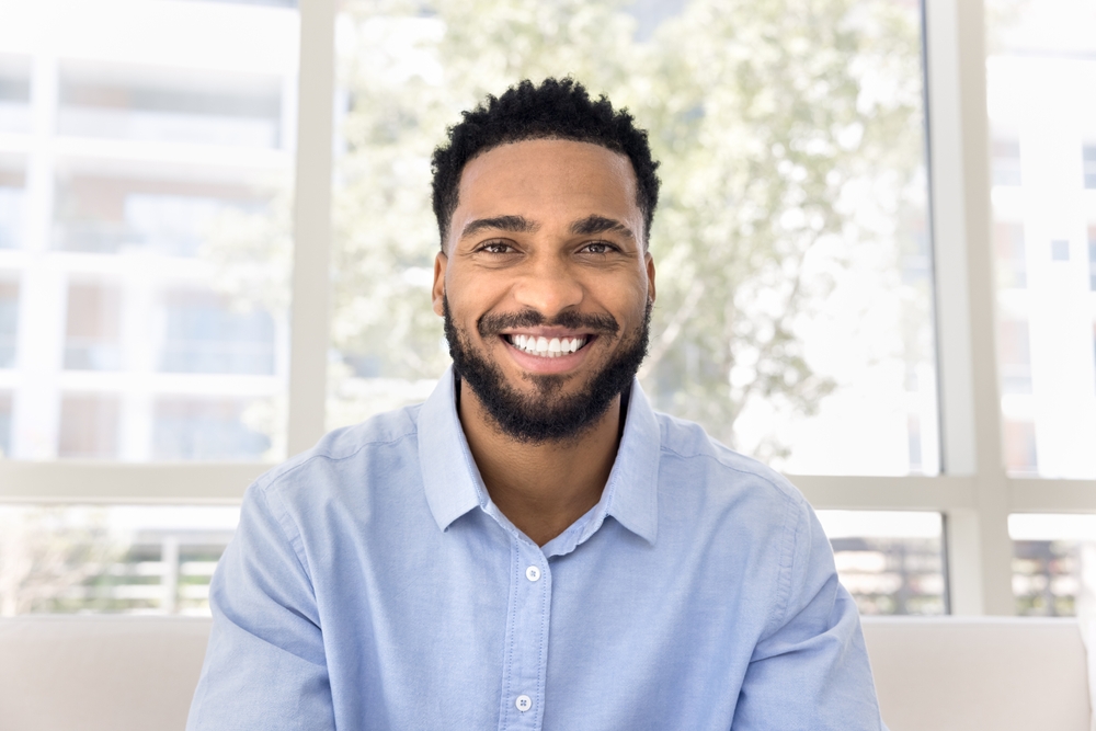 Man with a healthy, bright smile indoors in the Virginia Beach community 