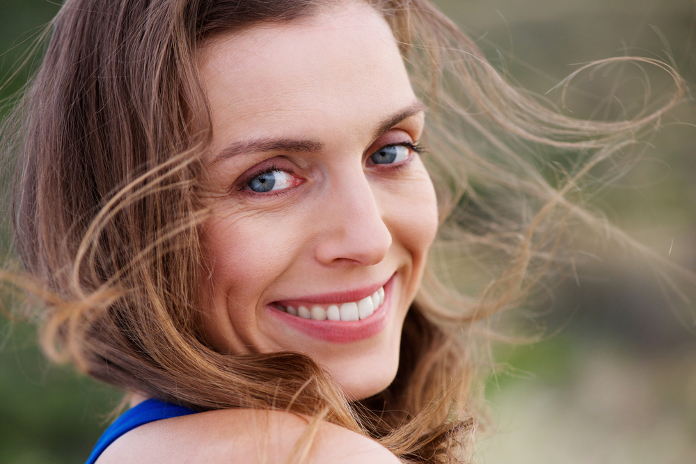Close up portrait of healthy smiling woman outside
