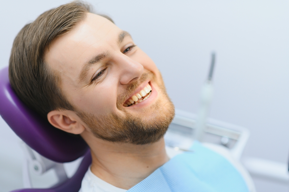 Dental care concept. Handsome young guy at the dentist's office