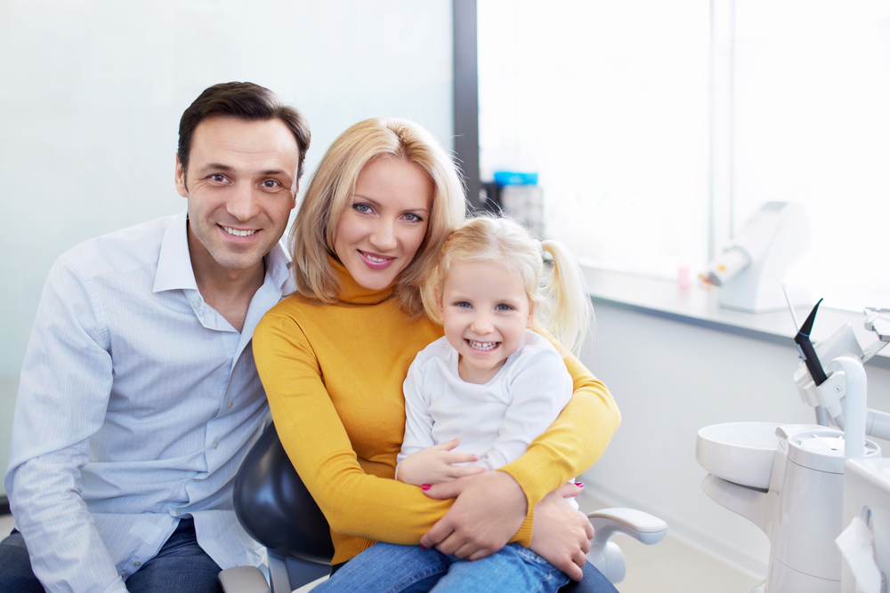 Happy family at our Norfolk dental office Family smiling together at our Norfolk, VA office
