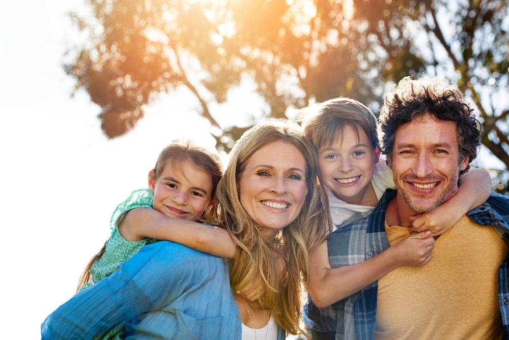 Family dentistry: care for families in the Norfolk community Family enjoying time outdoors together, reflecting the family dentistry care available in the Norfolk community