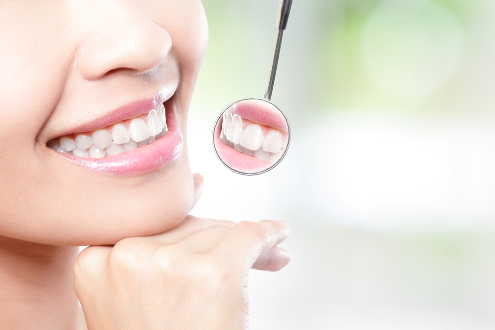 Close-up of a healthy smile reflected in a dental mirror during a Virginia Beach implant consultation 