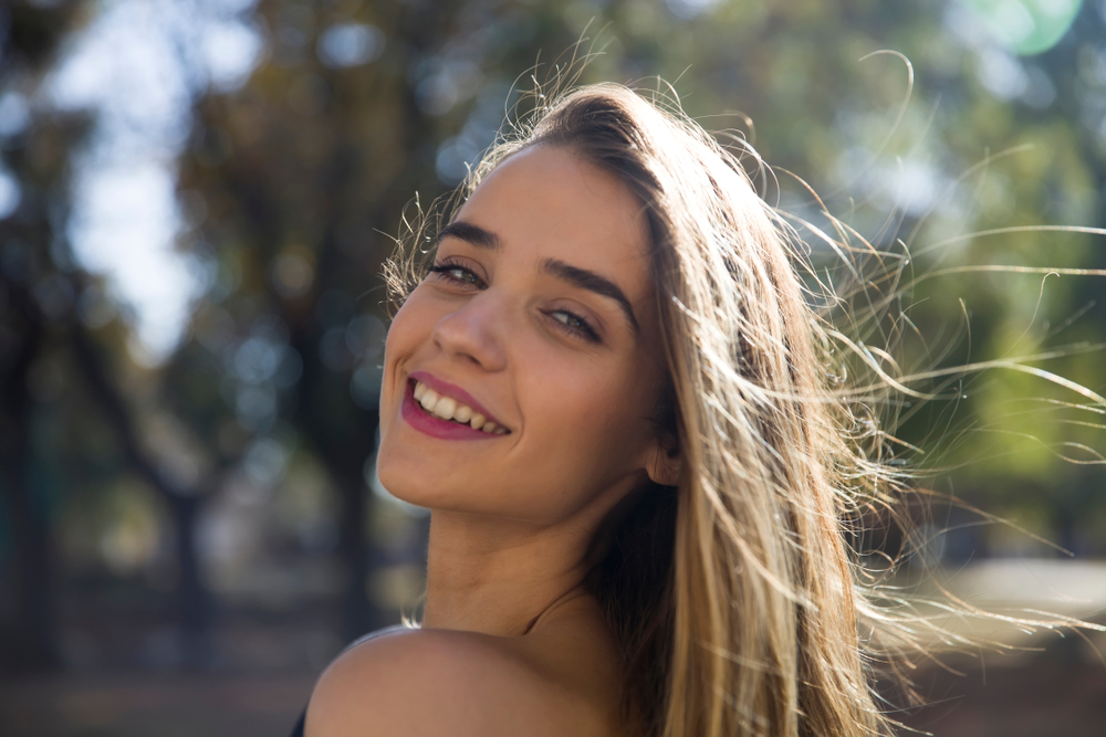 Woman with a bright smile outdoors in the Virginia Beach community 