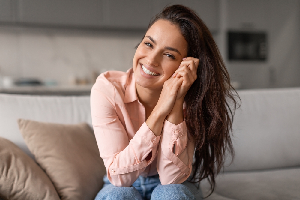 Bright Whitened Smile: Hampton Roads Teeth Whitening Results Smiling woman with a bright, whitened smile relaxing at home after teeth whitening in Hampton Roads