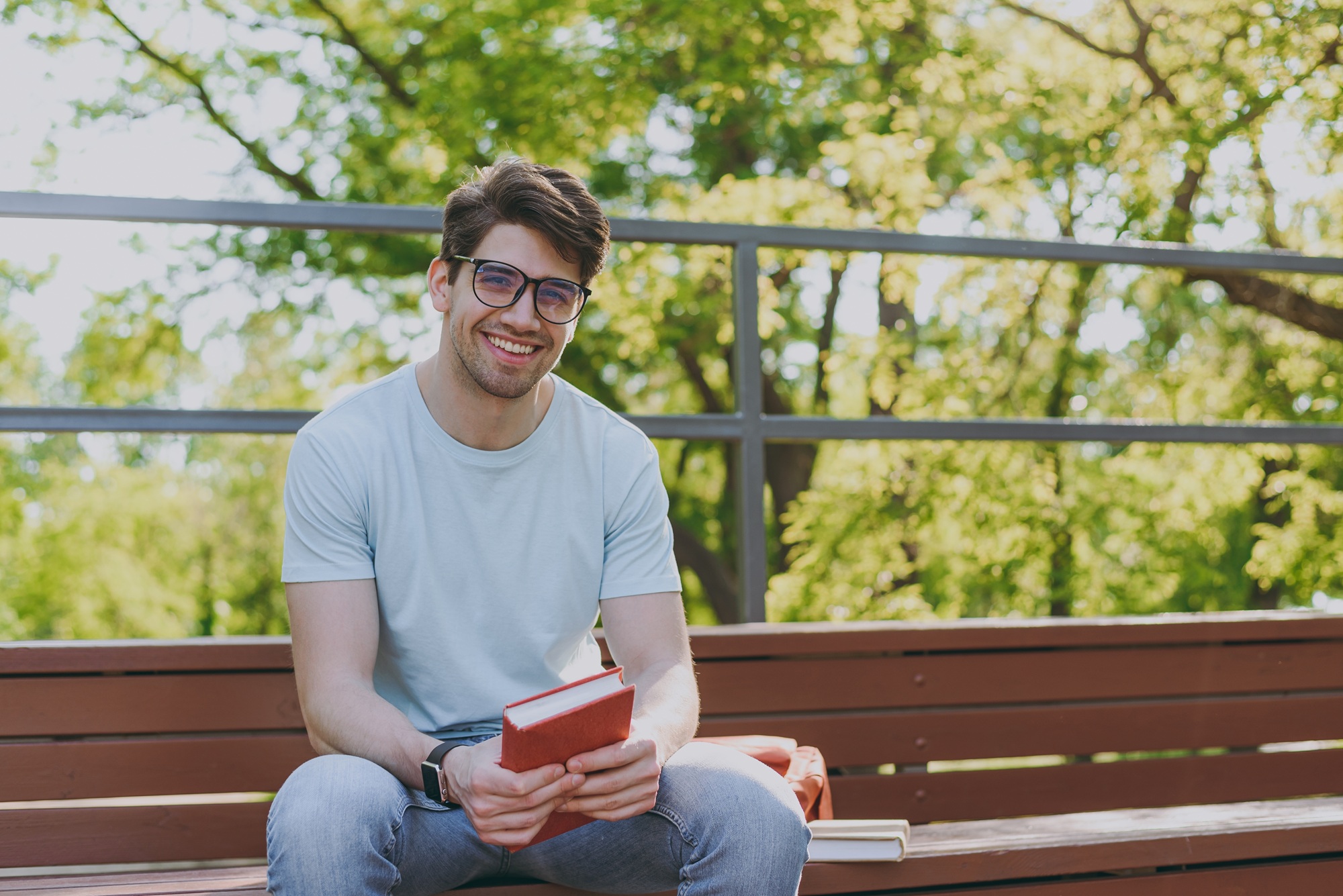 Bright Smile Outdoors: Norfolk Teeth Whitening Patient Smiling young man with a bright smile sitting outdoors after a teeth whitening visit in Norfolk