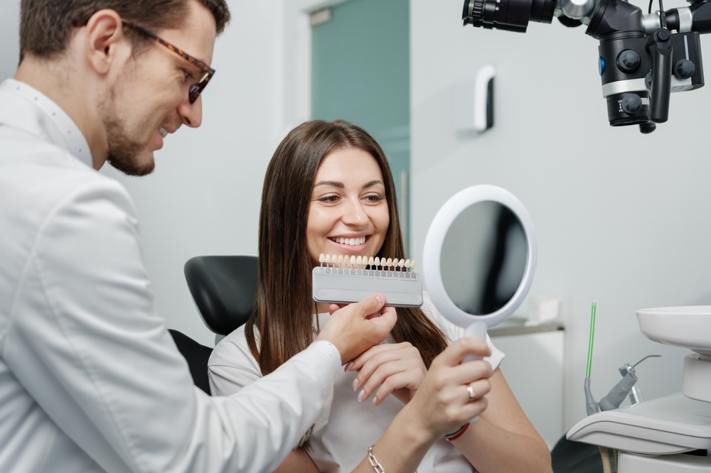 Cosmetic dentistry shade matching consultation at The Foleck Center, Virginia Beach, VA Dentist and female patient reviewing tooth shade options during a cosmetic dentistry consultation at The Foleck Center in Virginia Beach