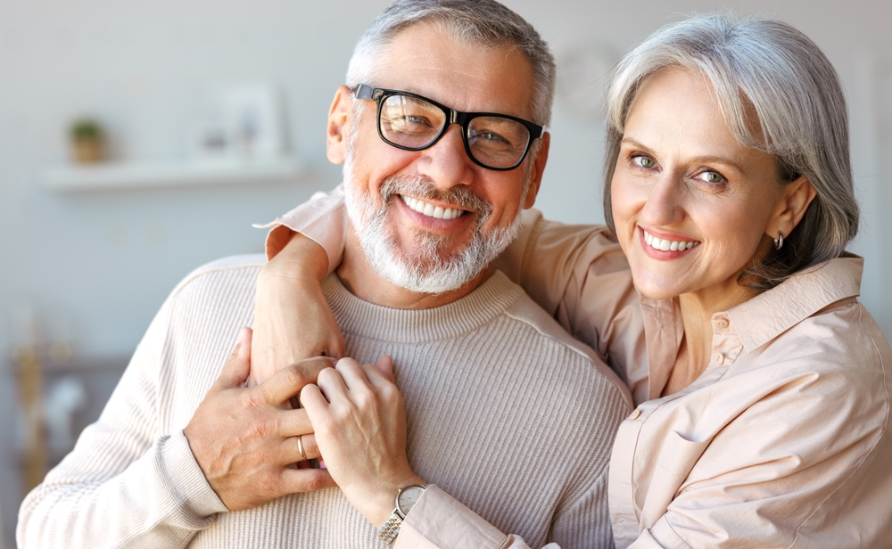 Senior Couple's Bright Smiles: Norfolk Teeth Whitening Patients Smiling senior couple with bright, whitened teeth after a teeth whitening visit in Norfolk