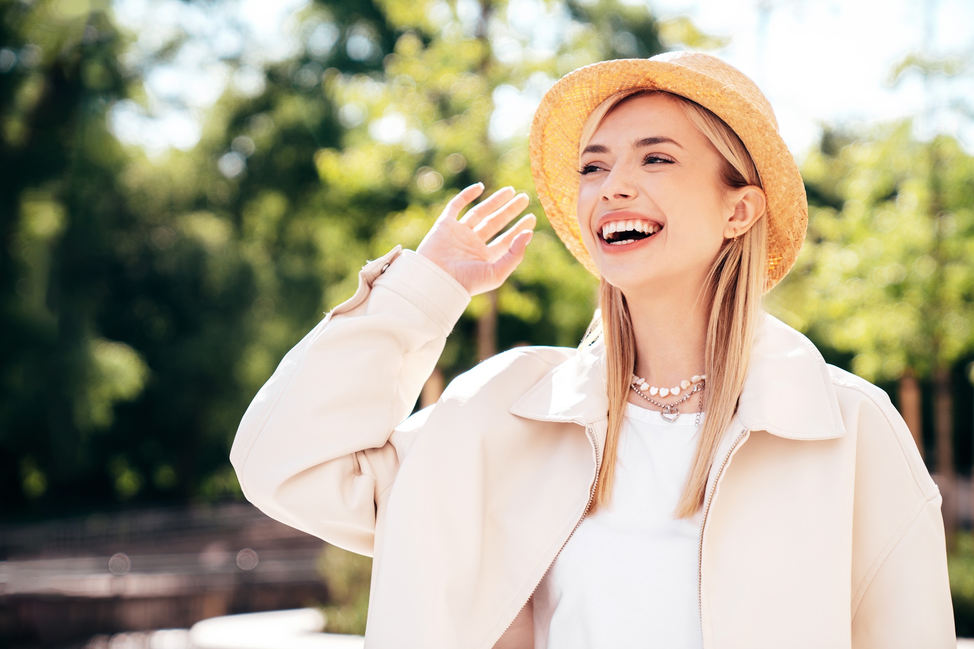 Joyful, confident smile: dental care in the Norfolk community Woman laughing joyfully outdoors, reflecting the confident smiles patients enjoy in the Norfolk community