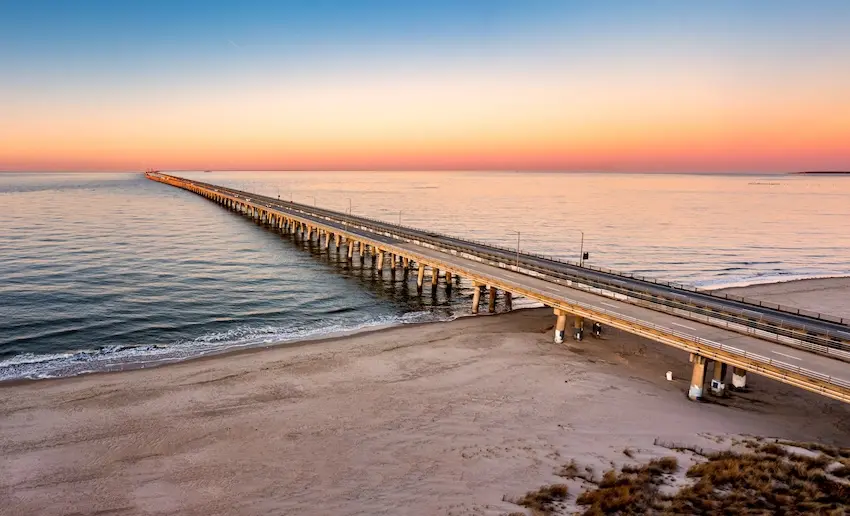 Chesapeake Bay Bridge-Tunnel, things to do near The Foleck Center, Chesapeake, VA Aerial view of the Chesapeake Bay Bridge-Tunnel at sunset, a landmark near The Foleck Center dental offices serving patients in the Chesapeake community