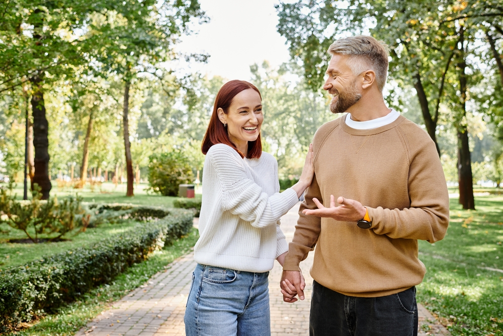 Youthful confidence: Botox treatments in Hampton Roads Mature couple laughing together while walking outdoors in a park