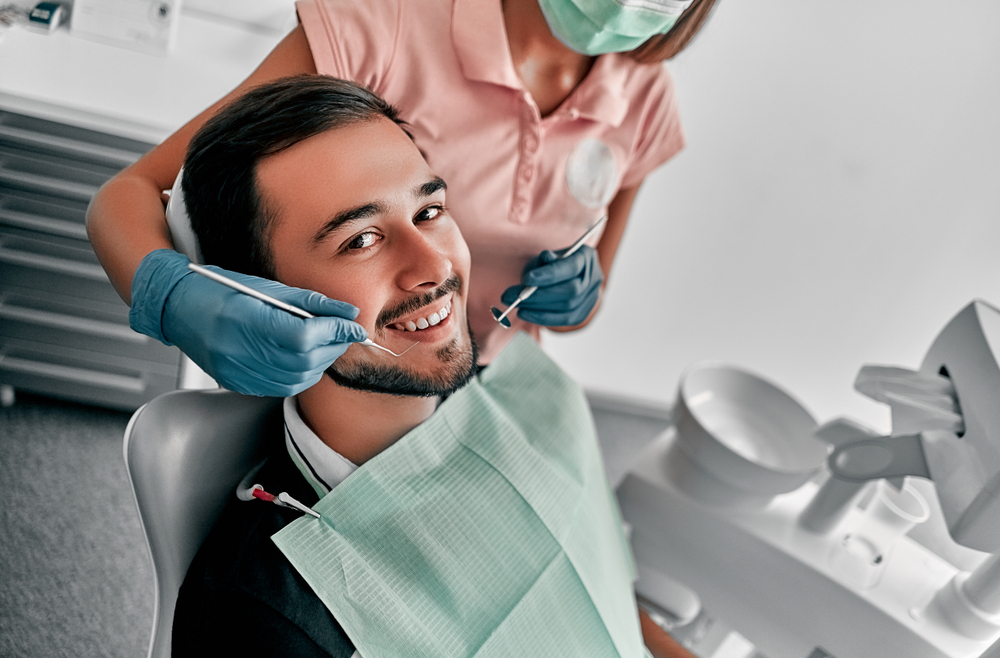 Smiling male patient in the dental chair during a dental inlay checkup at The Foleck Center in Virginia Beach 