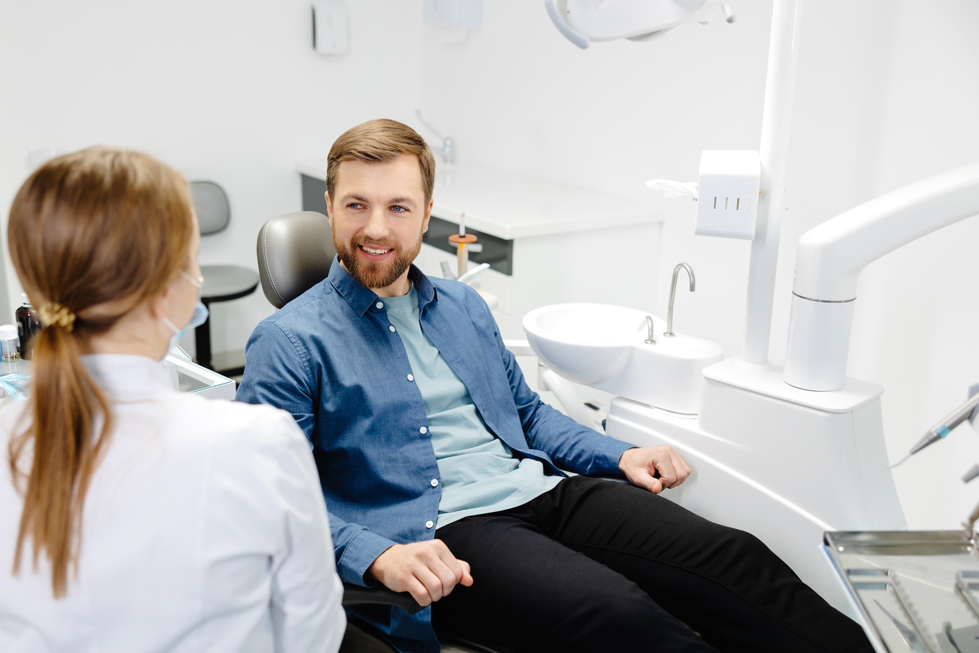 Restorative dentistry consultation: Norfolk dental office Dentist consulting with a patient in the treatment chair about restorative dentistry options at our Norfolk dental office