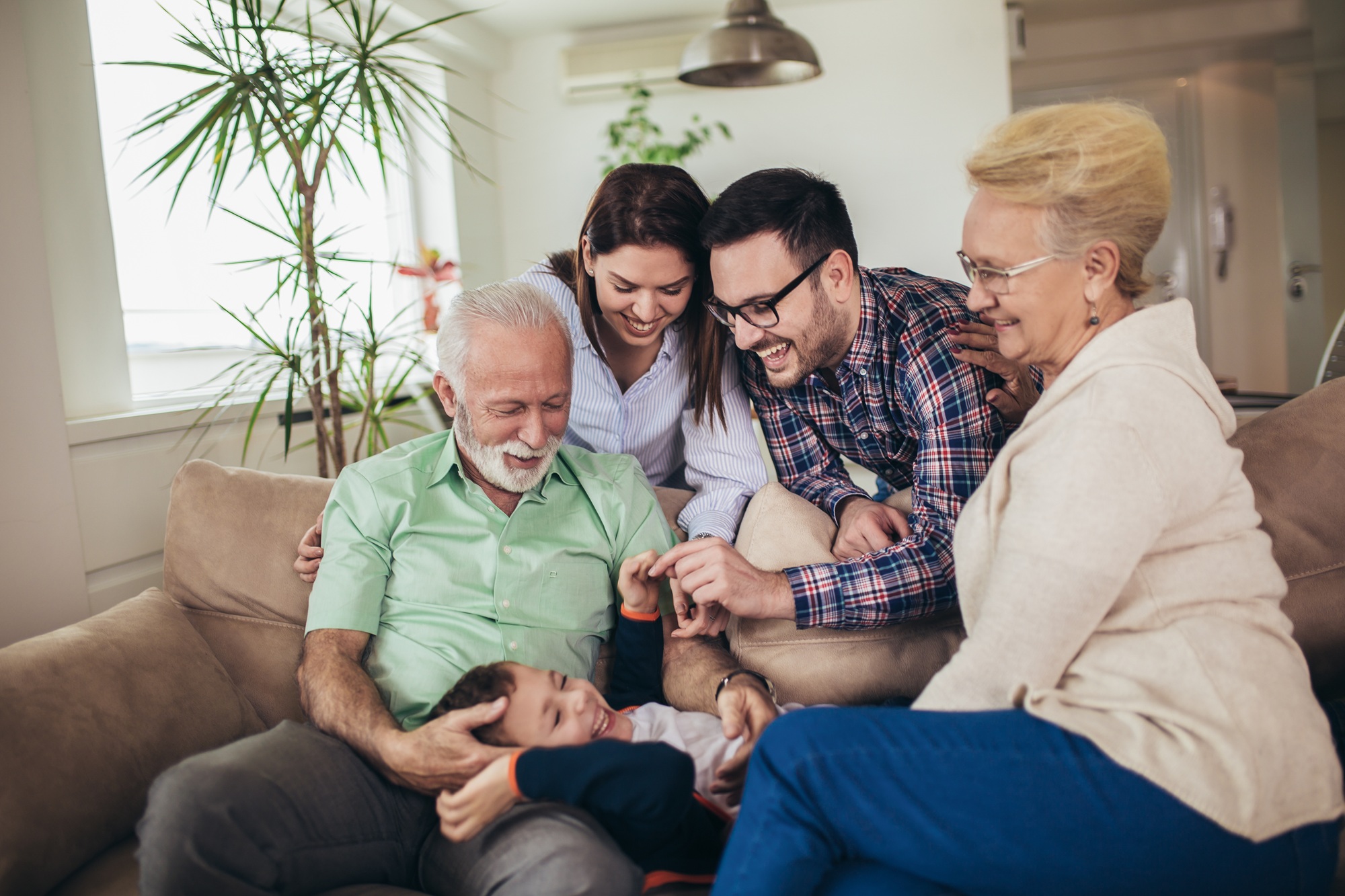 Family bonding at home in the Hampton community Multi generational family laughing together at home in the Hampton community