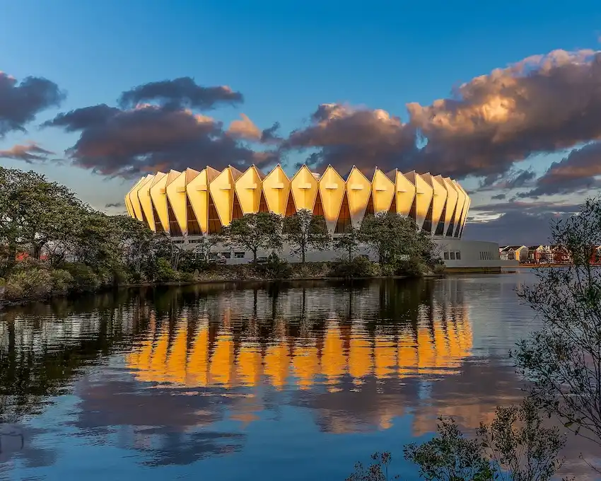 Hampton Coliseum landmark near The Foleck Center, Hampton, VA Hampton Coliseum illuminated at dusk, reflected in the lake, a landmark near The Foleck Center dental office in Hampton, VA