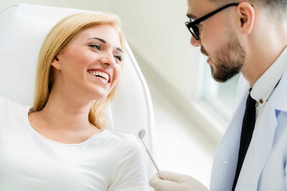 Patient consultation at our Norfolk dental office Patient smiling with her dentist at our Norfolk, VA office