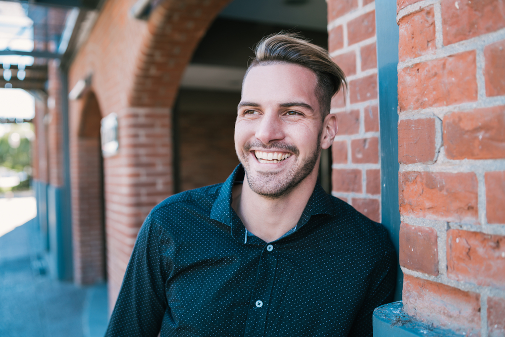 Man with a healthy smile outdoors in the Hampton community 