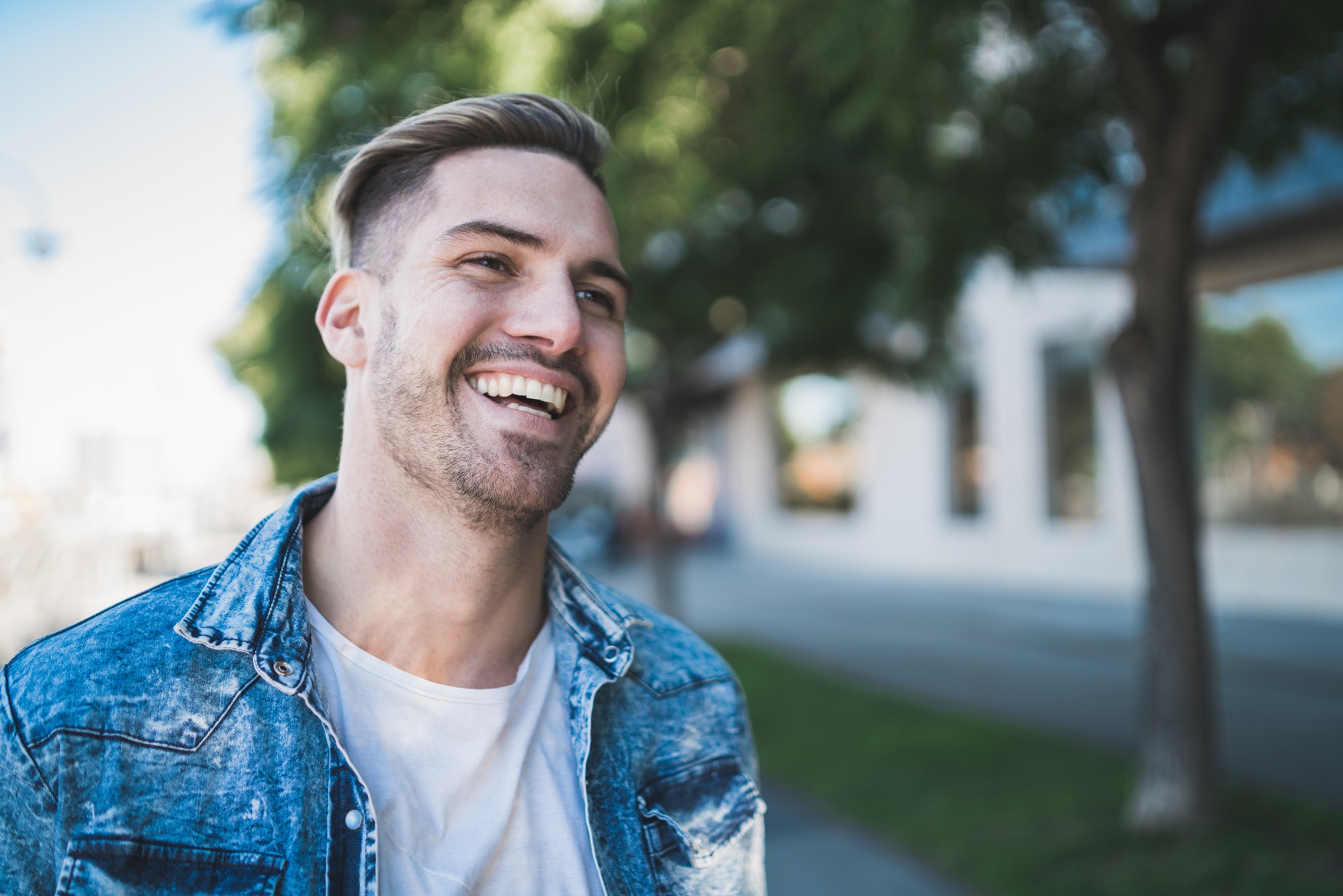 Smiling man with bright, straight teeth outdoors, reflecting confidence after dental bonding at The Foleck Center, Norfolk, VA 