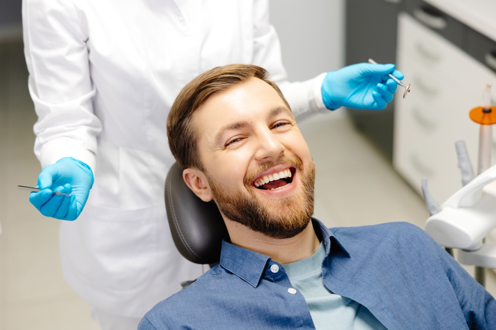 Dental care in Norfolk, VA, The Foleck Center Smiling male patient in the dental chair during a visit to The Foleck Center, Norfolk, VA