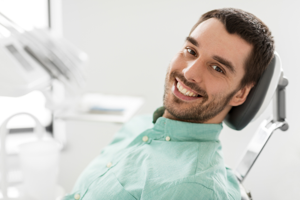 Restorative dentistry patient: Hampton Roads Patient smiling in the treatment chair before a restorative dentistry procedure in Hampton Roads