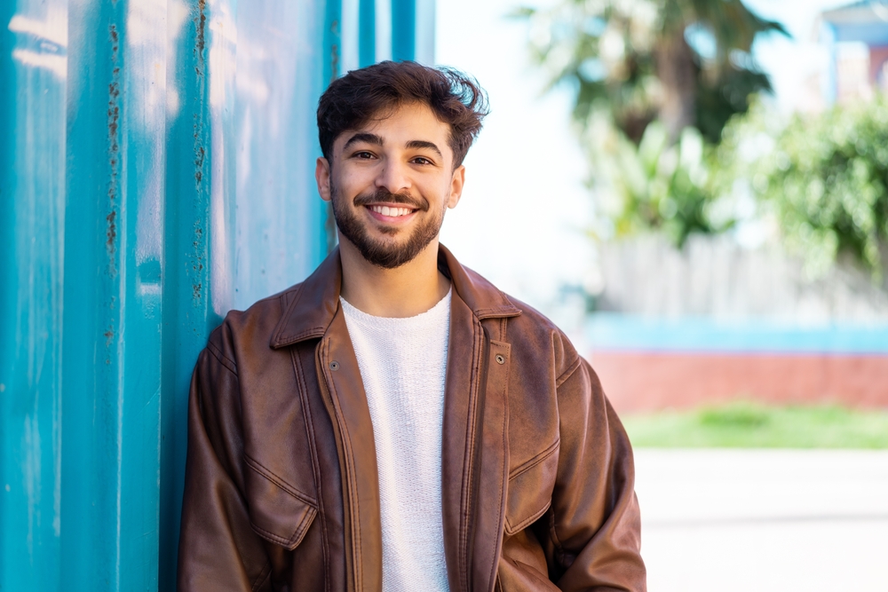 Healthy smile: family dentistry in the Norfolk community Young man smiling outdoors, representing the healthy smiles achieved through family dentistry in the Norfolk community