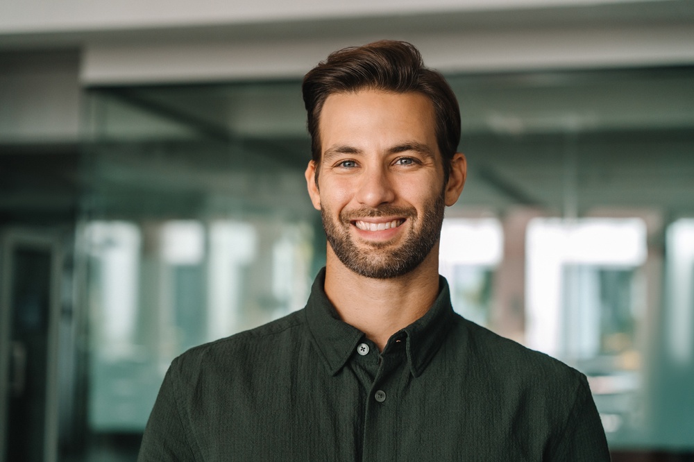 Restored smile, full mouth reconstruction in Hampton Roads Man smiling confidently in a professional headshot