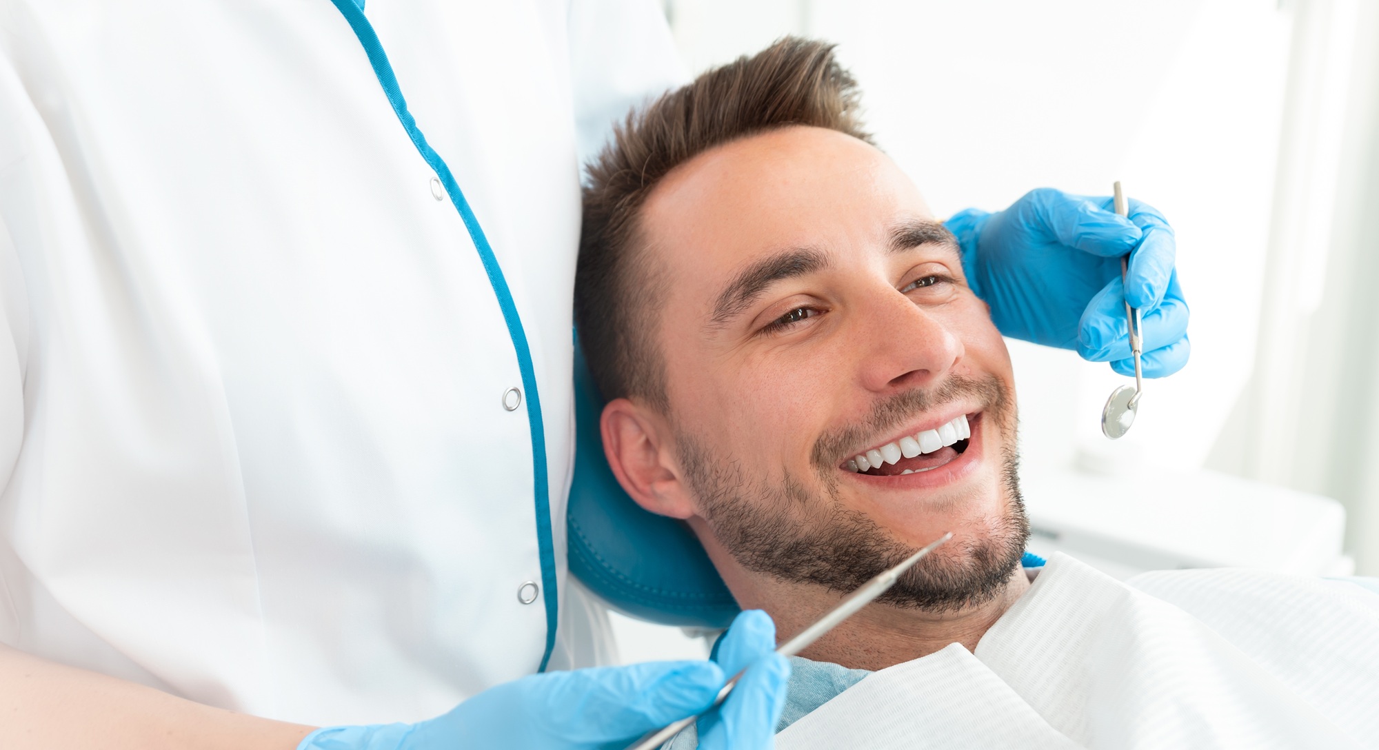 Dental checkup and exam at our Hampton dental office Patient smiling during a dental exam at our Hampton, VA office