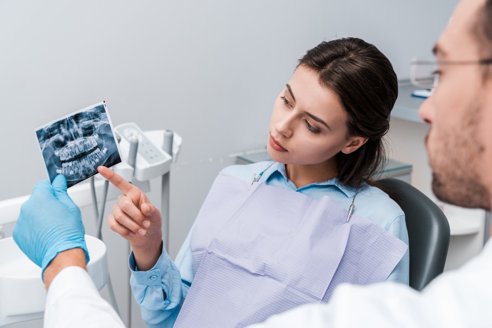 Patient reviewing a dental x-ray with her dentist at our Virginia Beach, VA office 