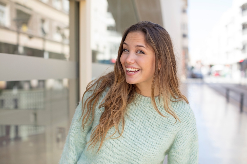 pretty hispanic woman with a big, friendly, carefree smile, looking positive, relaxed and happy, chilling