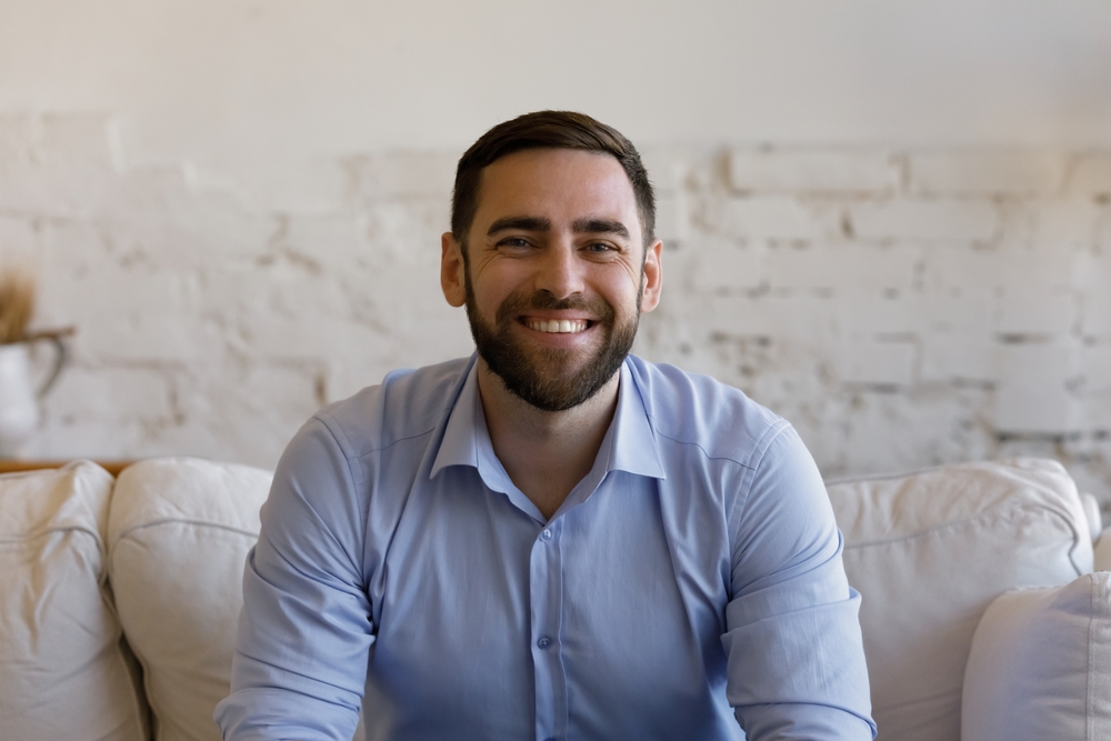 Healthy, confident smile in the Norfolk community Man with a healthy, bright smile indoors in the Norfolk community