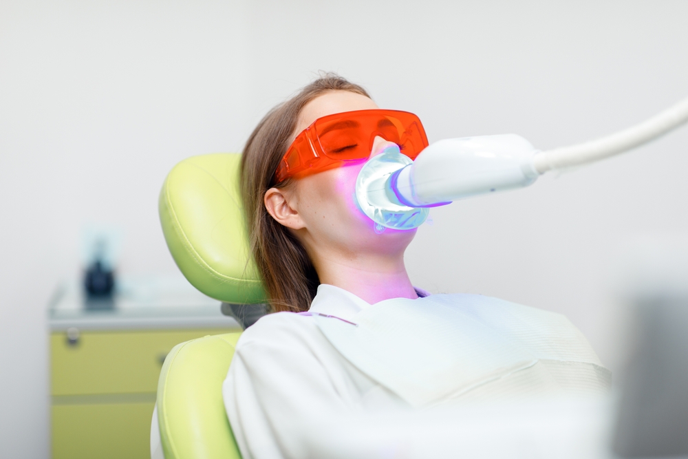 teeth whitening, Dentist starting teeth, whitening procedure, white teeth, receiving teeth cleaning