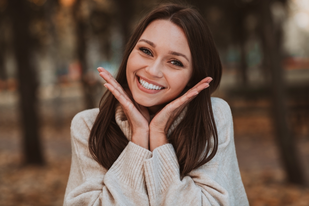 Woman with a bright smile outdoors in the Hampton community 