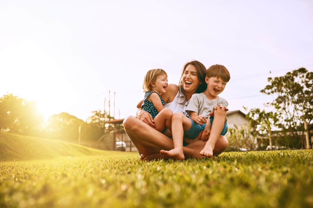 Mother laughing with her two children outdoors in the Hampton community 