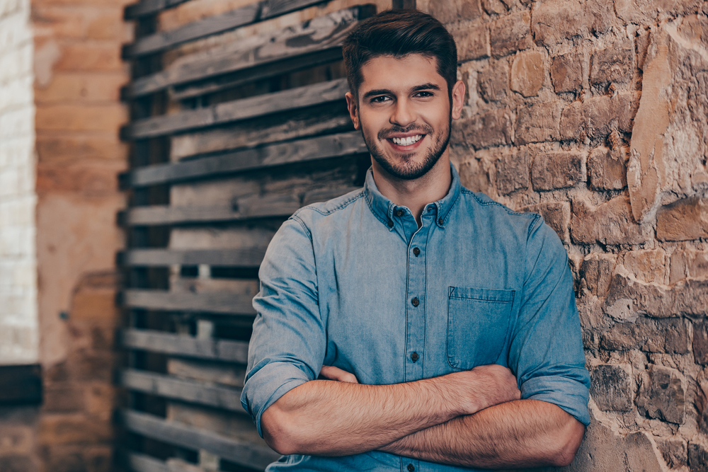 Confident Smile After Dental Filling: Norfolk Patient Confident young man smiling outdoors with a healthy, restored smile after dental filling treatment in Norfolk