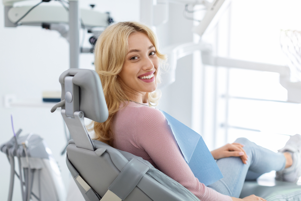 Dental implants in Norfolk, VA, The Foleck Center Woman smiling confidently in the dental chair during a dental implant consultation at The Foleck Center, Norfolk, VA